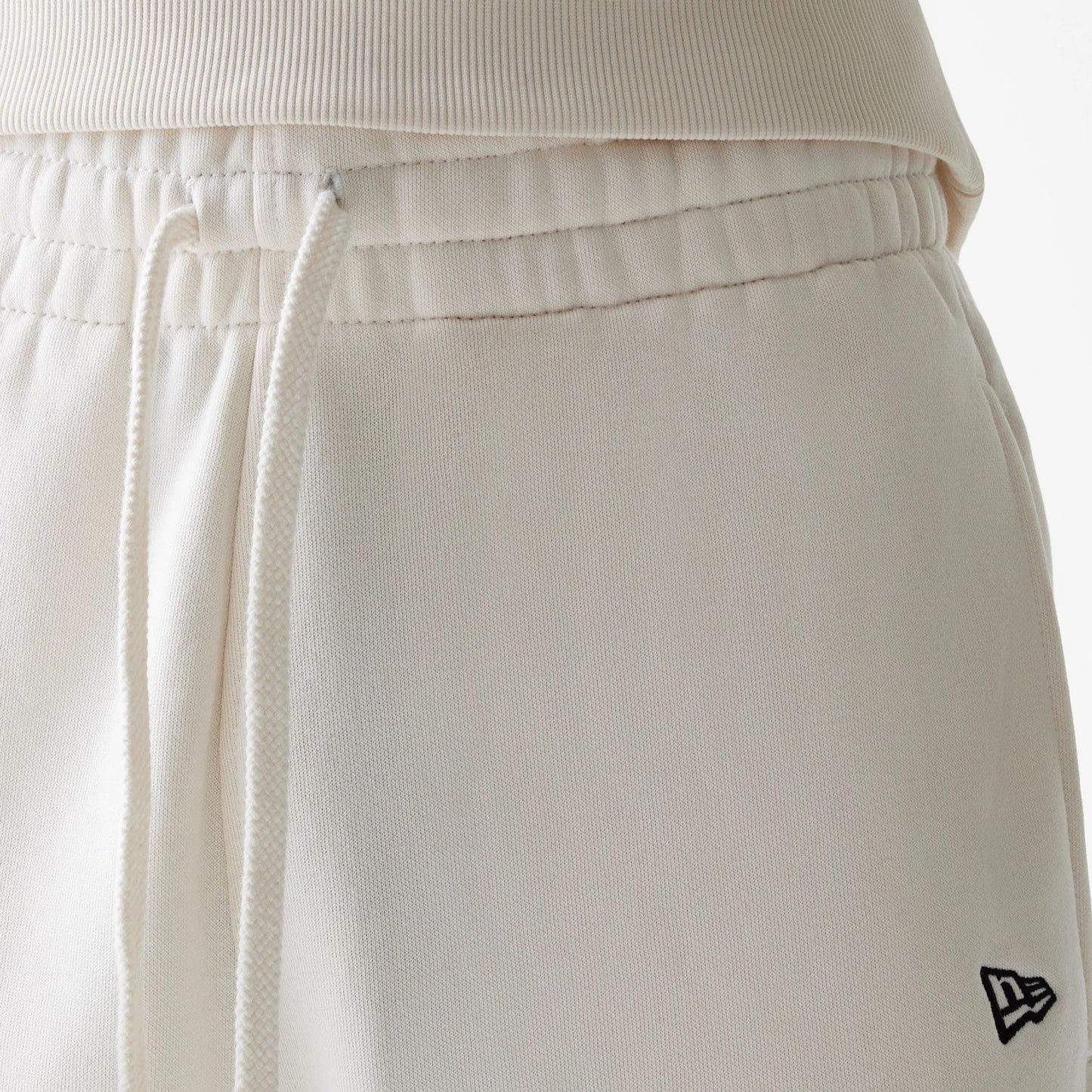 The Male model is wearing New Era Open White Oversized One Panel Shorts 4