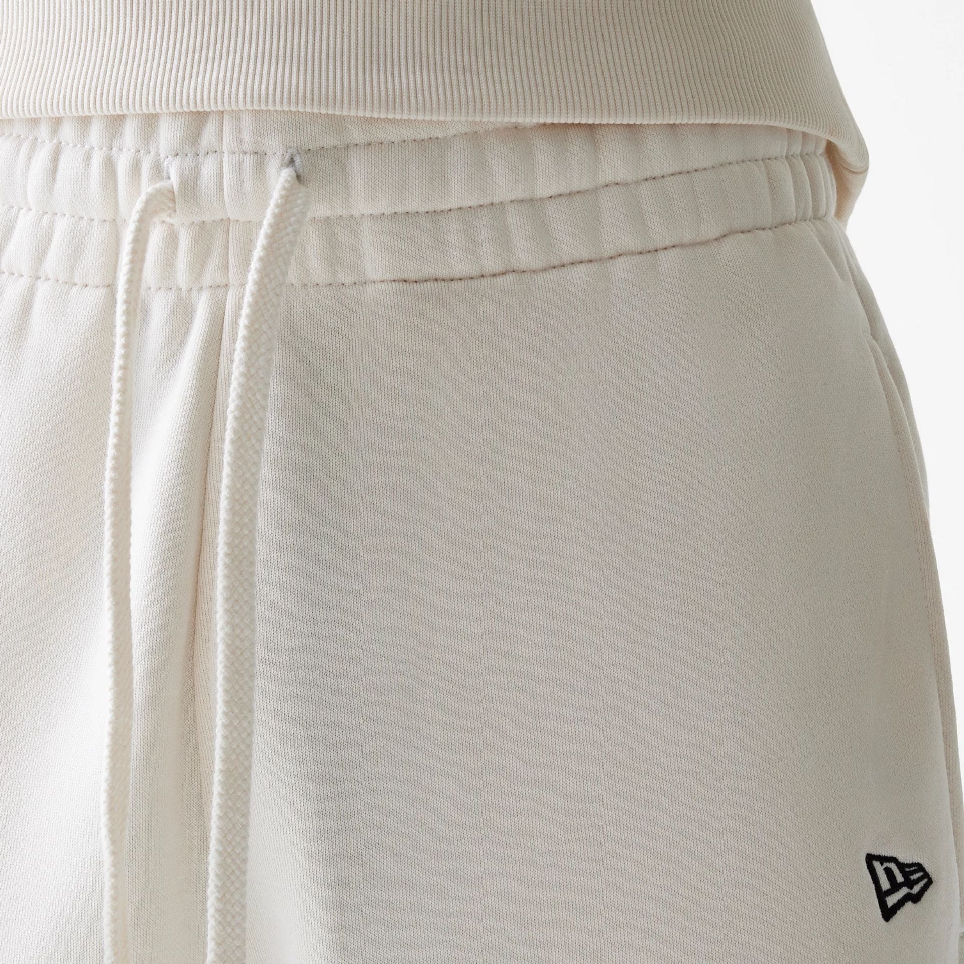 The Male model is wearing New Era Open White Oversized One Panel Shorts 4