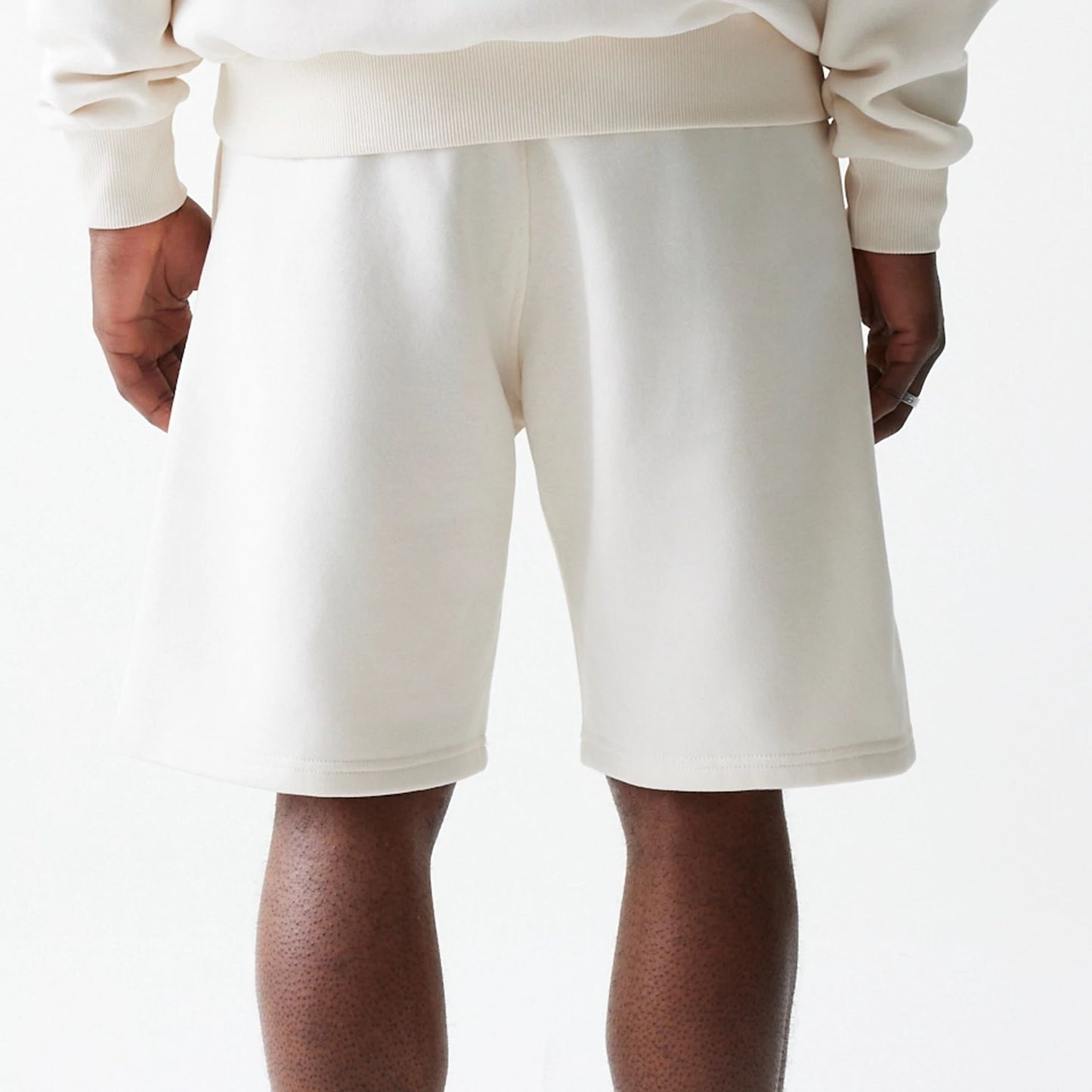 The Male model is wearing New Era Open White Oversized One Panel Shorts 7