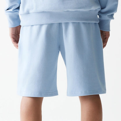 The Male model is wearing New Era Pastel Blue Oversized One Panel Shorts 7