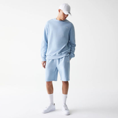 The Male model is wearing New Era Pastel Blue Oversized One Panel Shorts 8