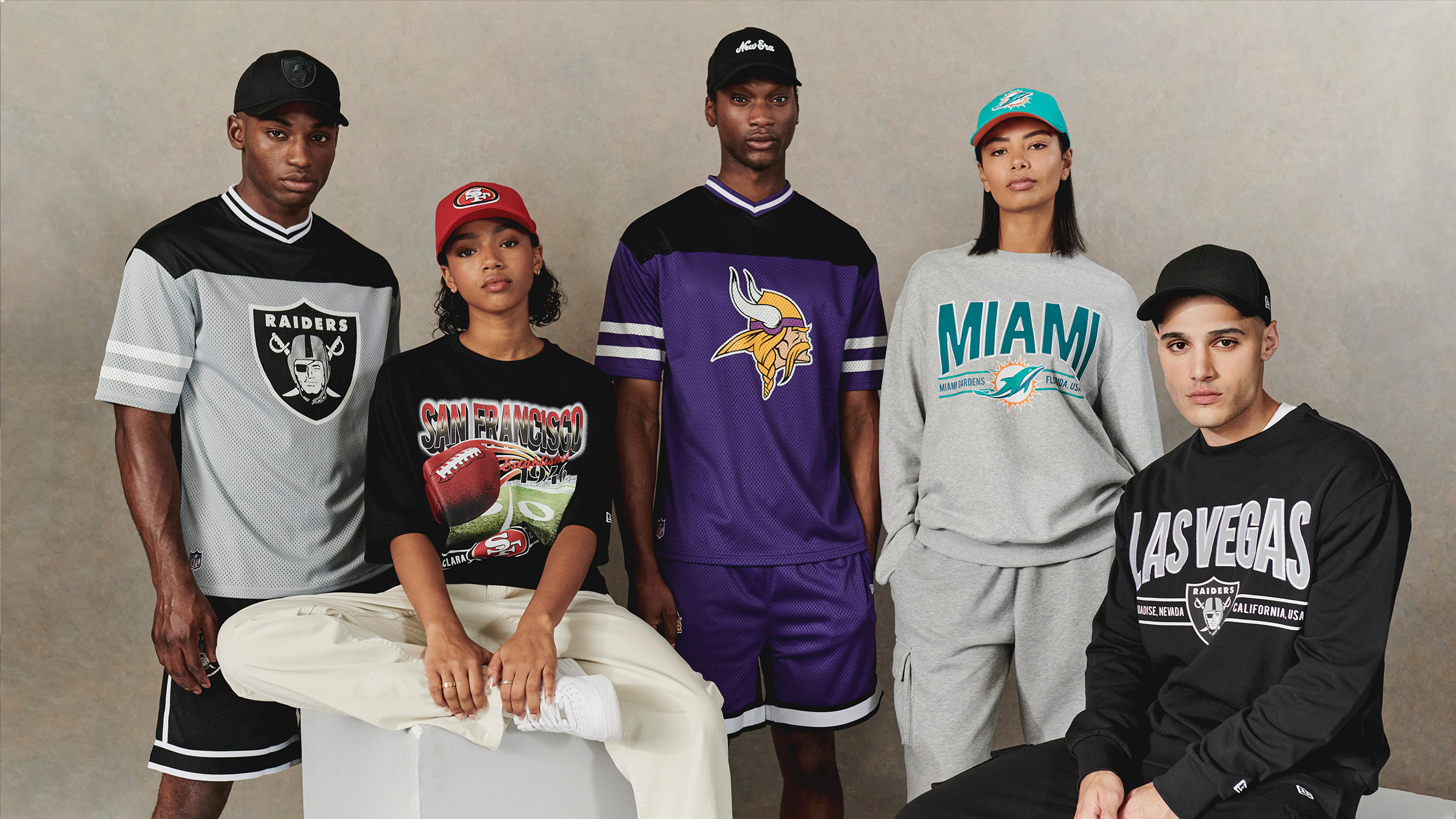 group of young adults wearing nfl hoodies, shorts and caps