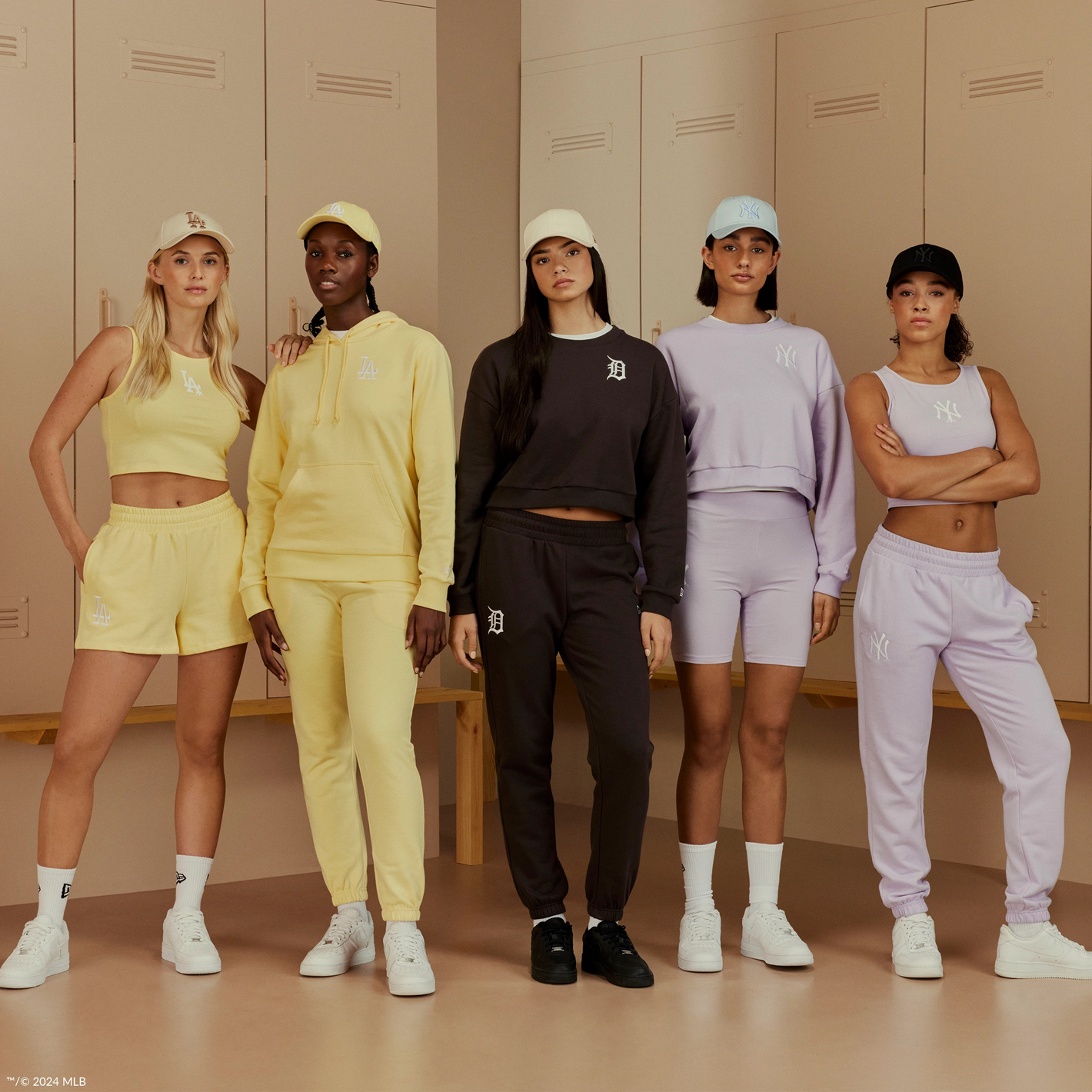 group of 5 young women standing wearin matching tracksuit and short sets