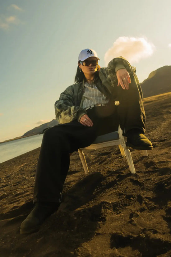 Slide 2:female wearing a white new york yankees cap for the New Era x Icelandic Rap collaboration.