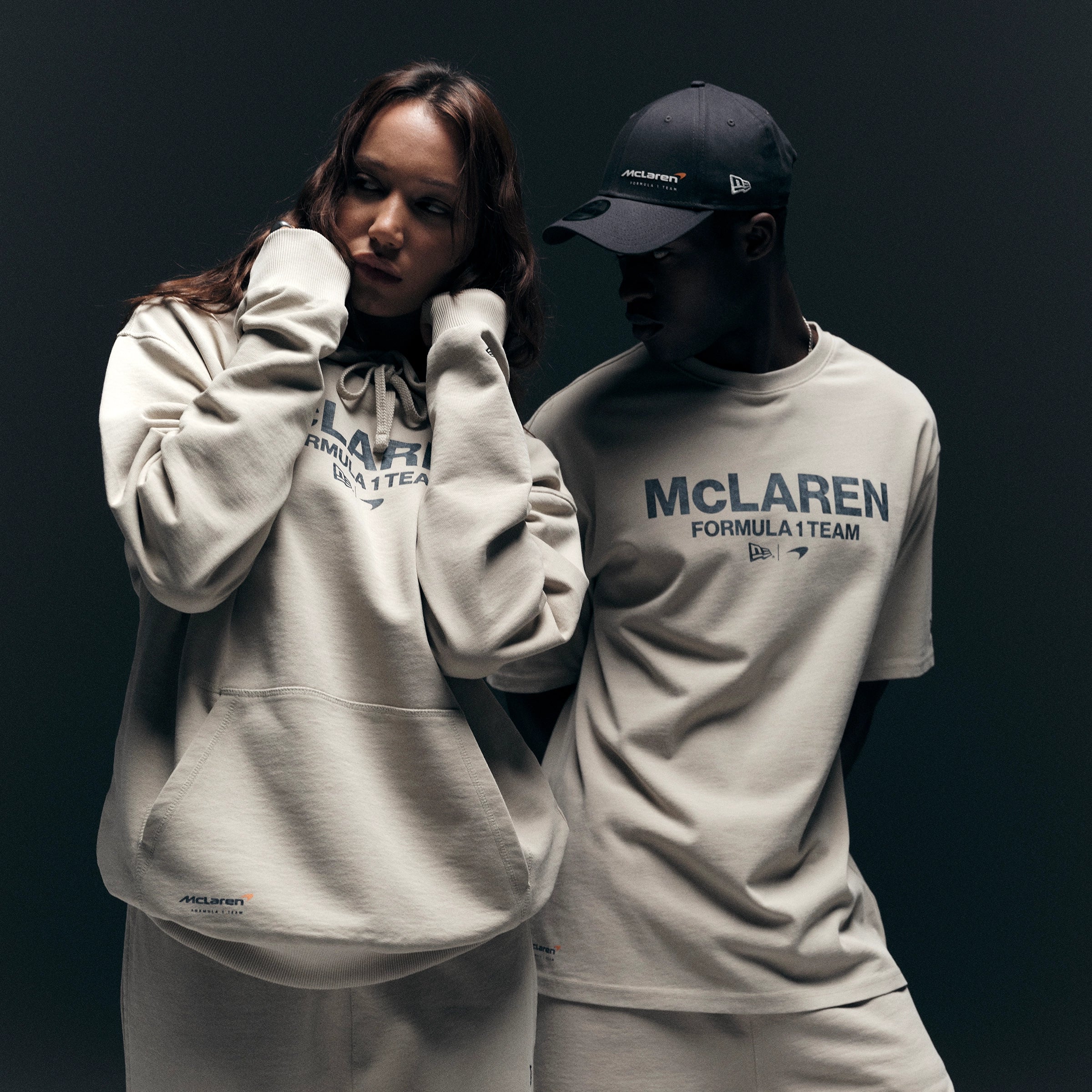 man and women wearing mclaren top and hoodie