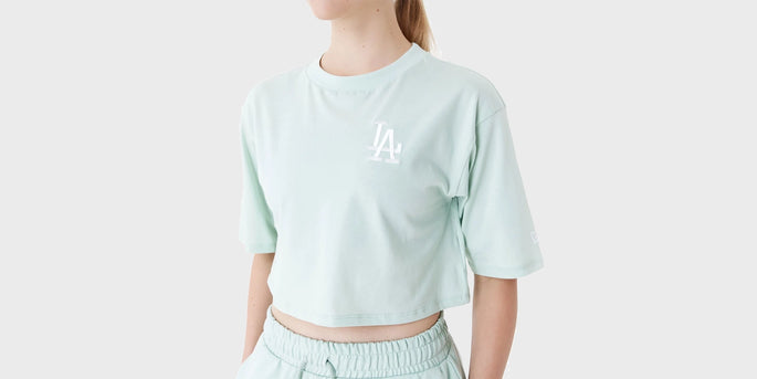 woman wearing a light green la dodgers cropped t-shirt