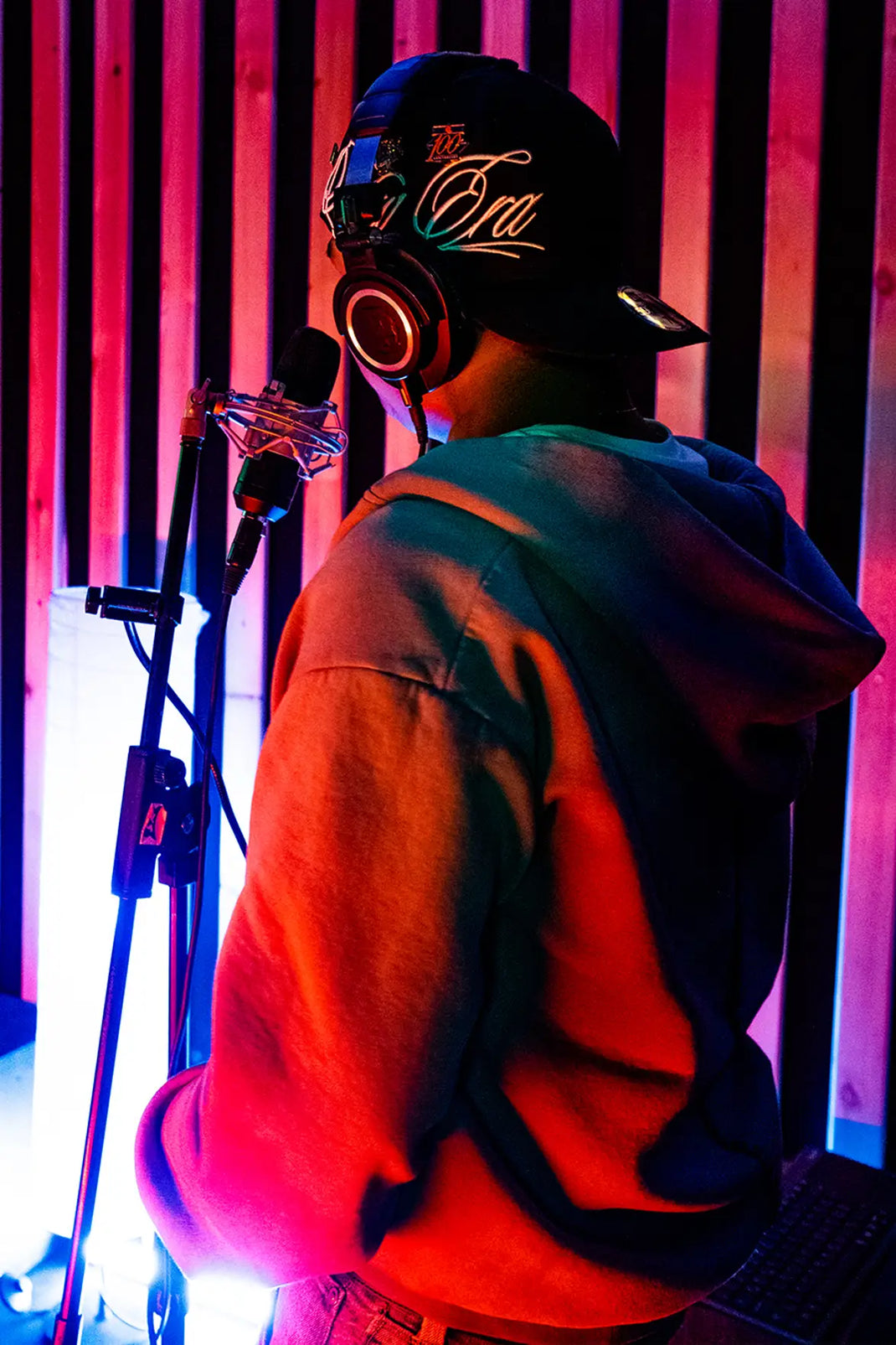 man in a recording studio wearing a green 59fifty for new era x icelandic rap collaboration