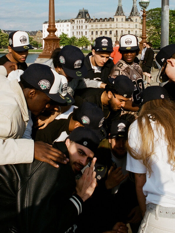 a group of young adults wearing new era x kesi 59FIFTY cap