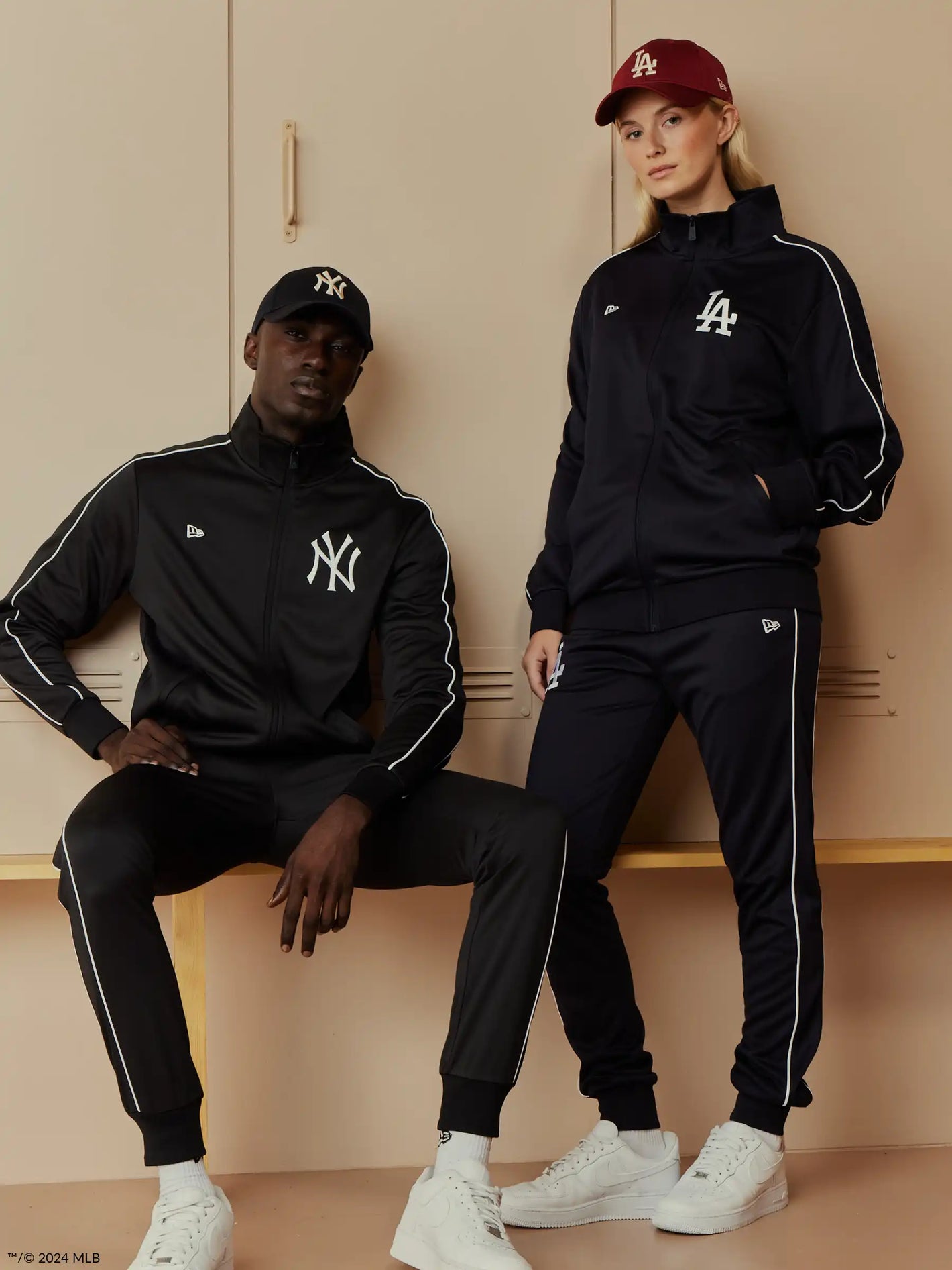 male and female model wearing ny yankees tracksuits 