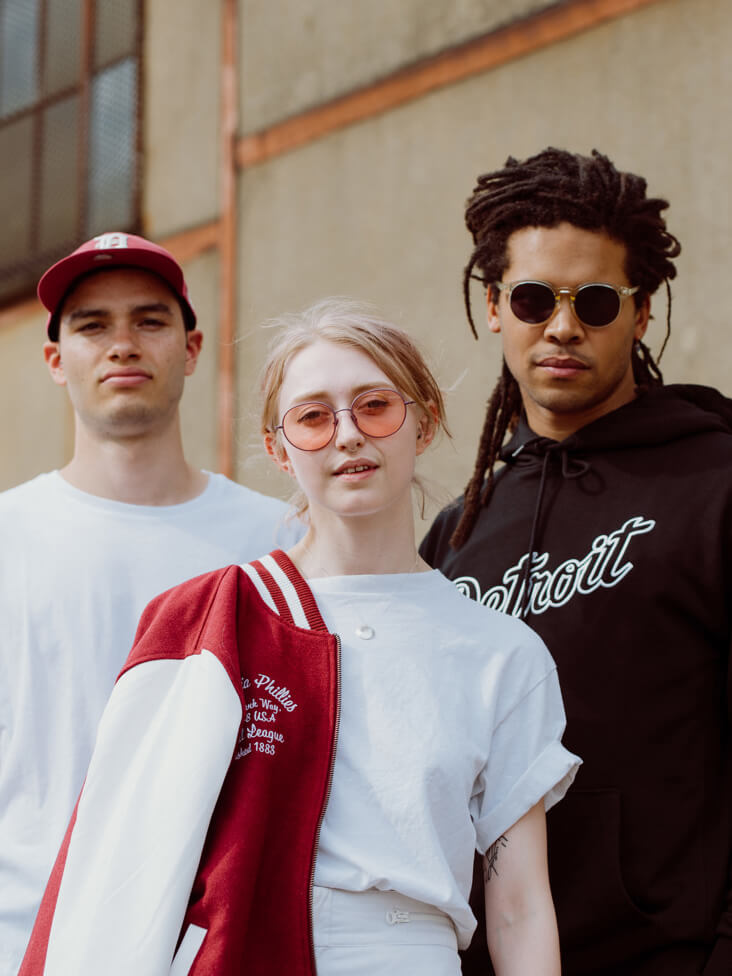 two male models and one female model wearing MLB clothing