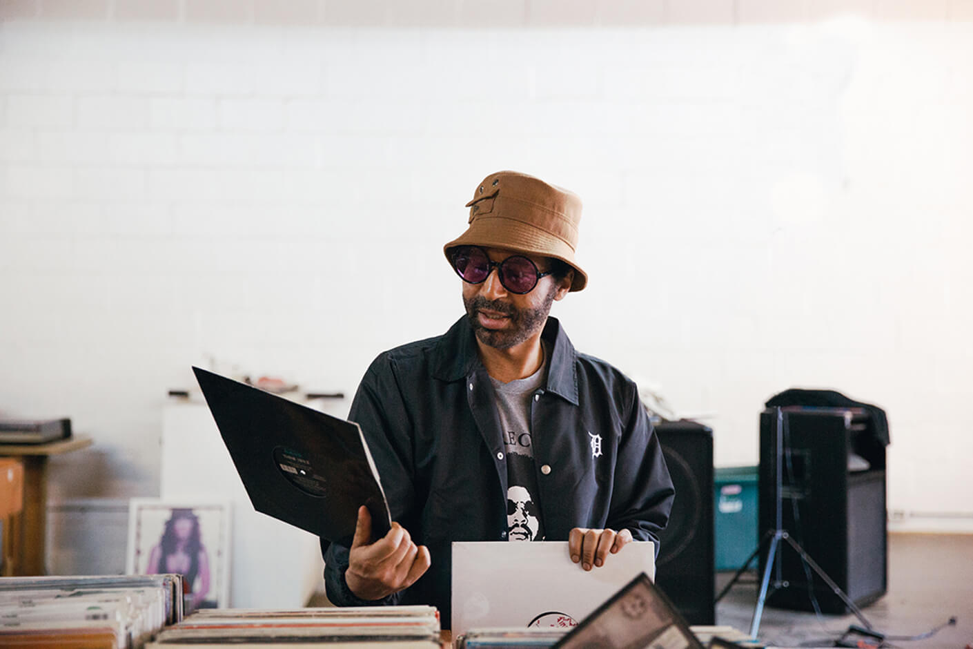 moodymann wearing a new era x moodymann beige bucket hat