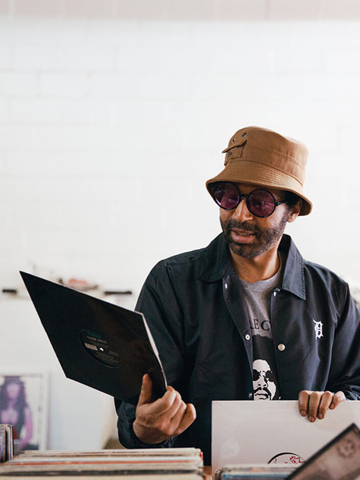 moodymann wearing a new era x moodymann beige bucket hat