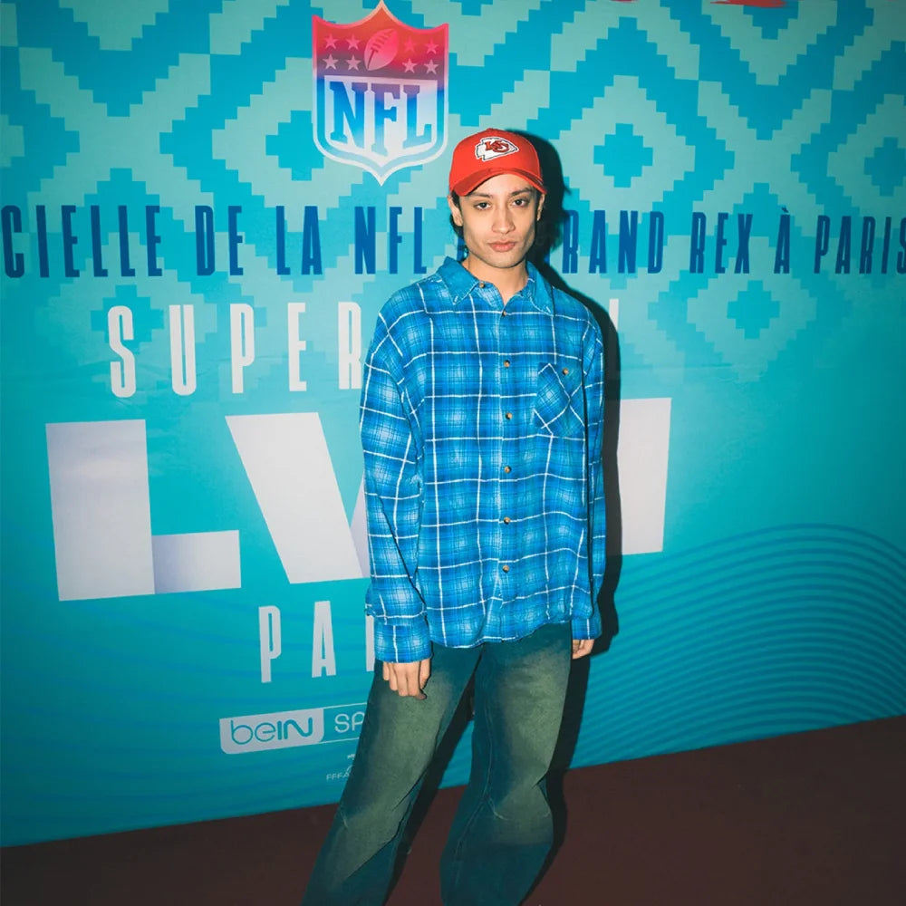 model posing at the Le Grand Rex with a red new era kansas city chiefs cap