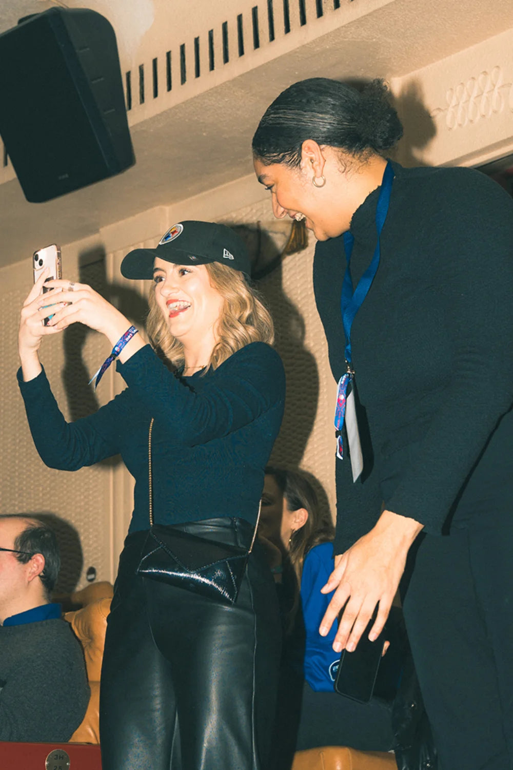 two females at the superbowl part 2023, one wearing a black new era pitstburgh steelers cap