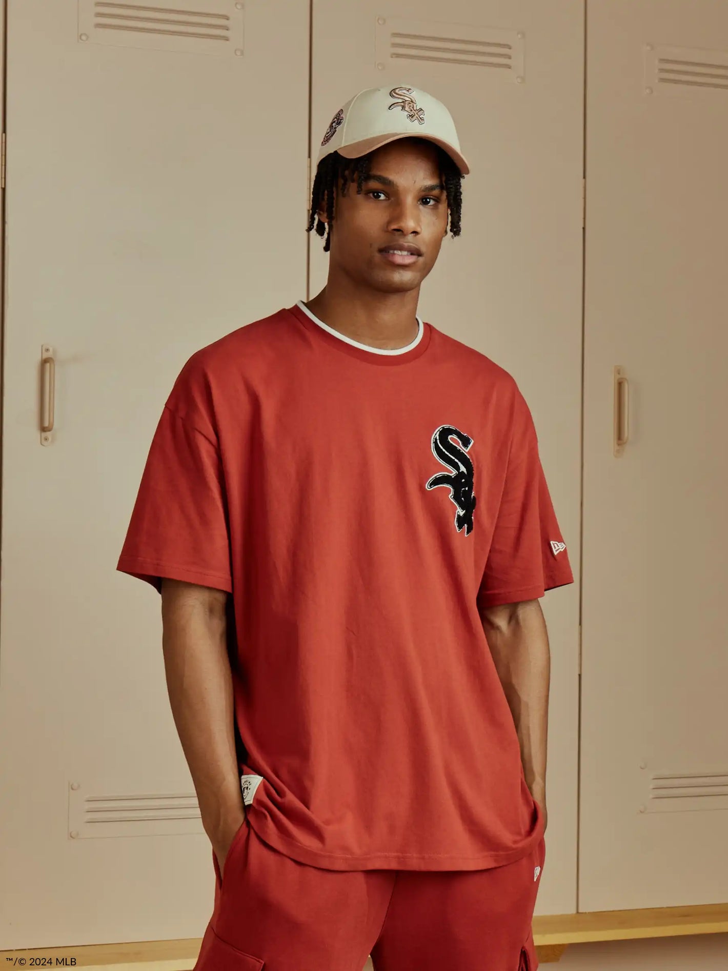 male model wearing a red chicago white sox t-shirt and beige white sox cap