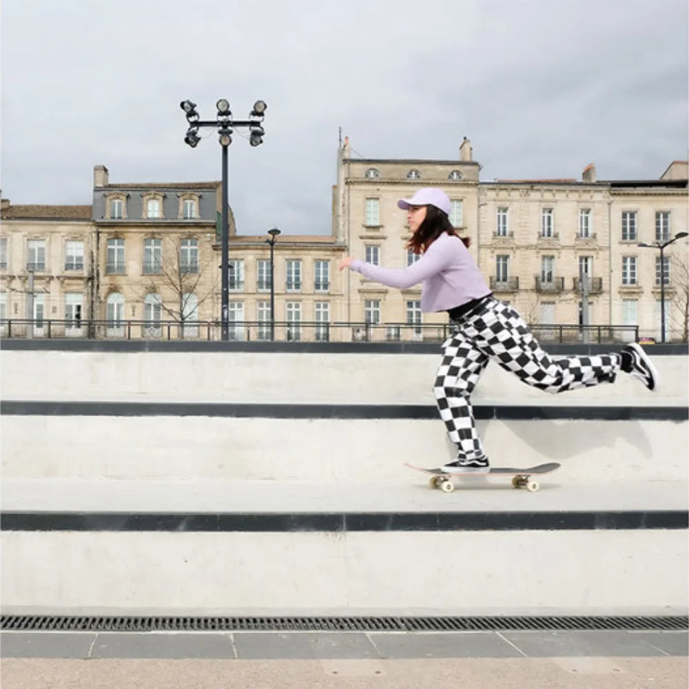 shani bru on a skateboard wearing a purple new era cap