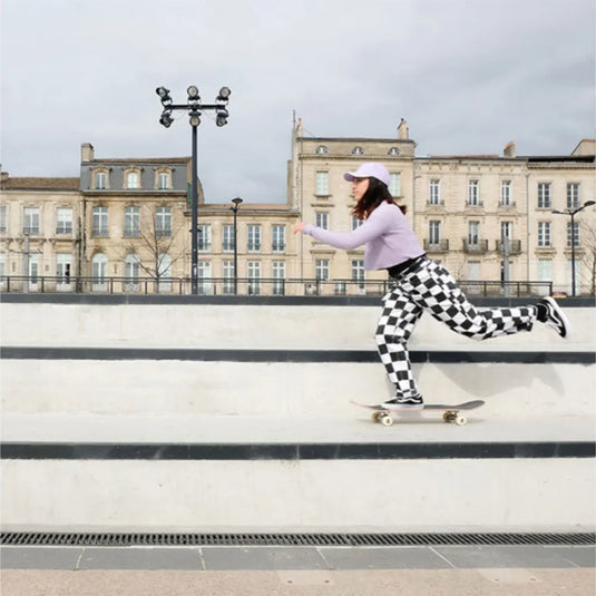 shani bru on a skateboard wearing a purple new era cap