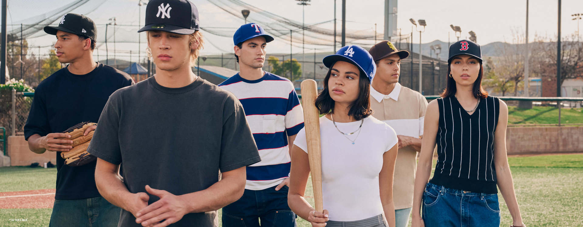 men and women on a baseball field wearing new era baseball caps for desktop